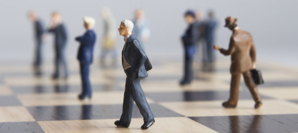 Business figurines placed on chessboard